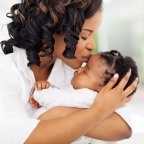 Mum kissing baby